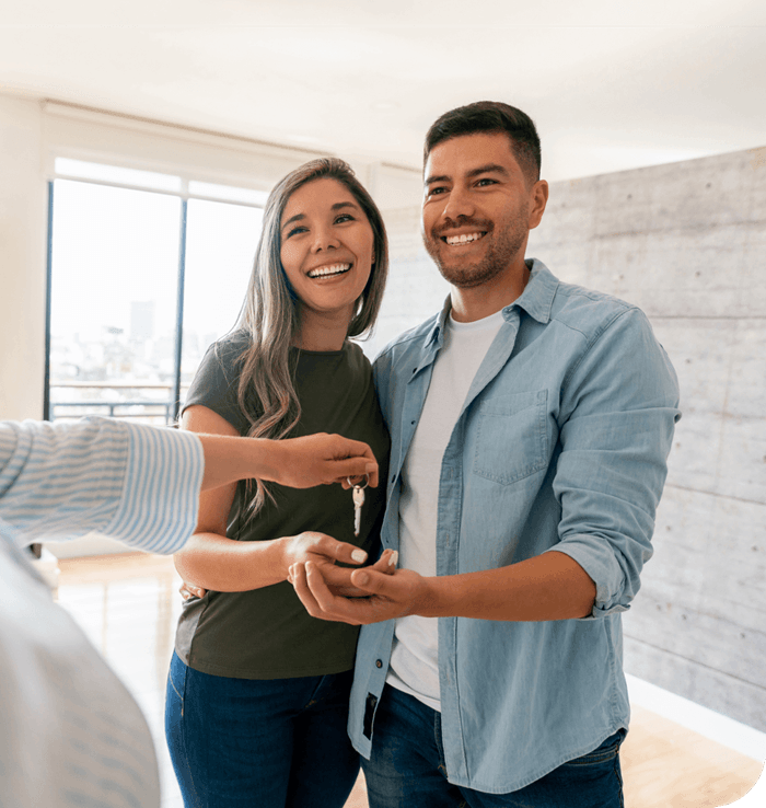 New homeowners get house keys after closing with lender